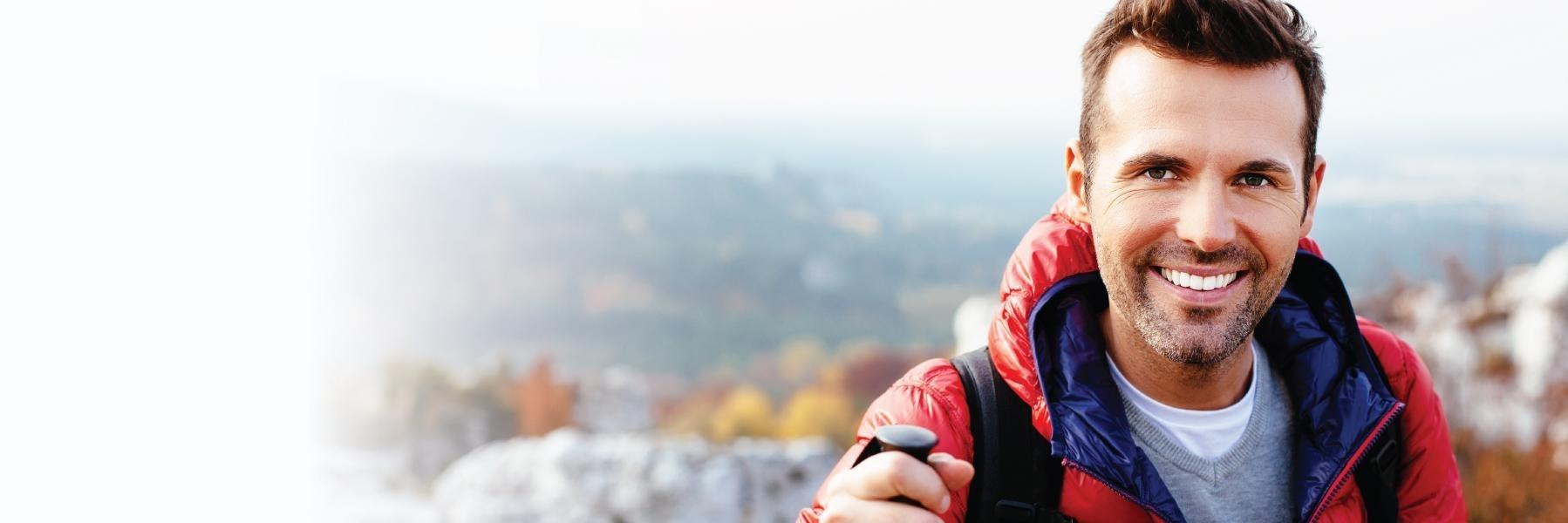 Man with replaced missing teeth smiling