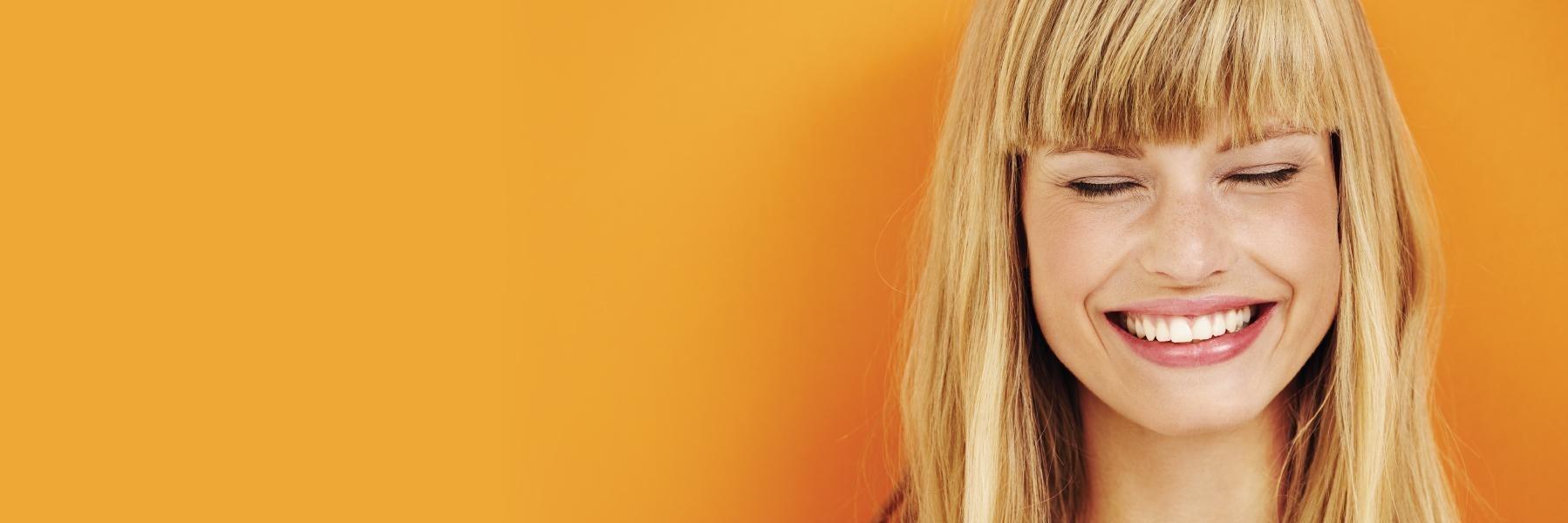 Girl smiling after root canal gets rid of her pain